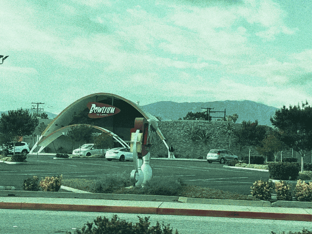 a bowling alley with a tall parabolic facade, named Bowlium