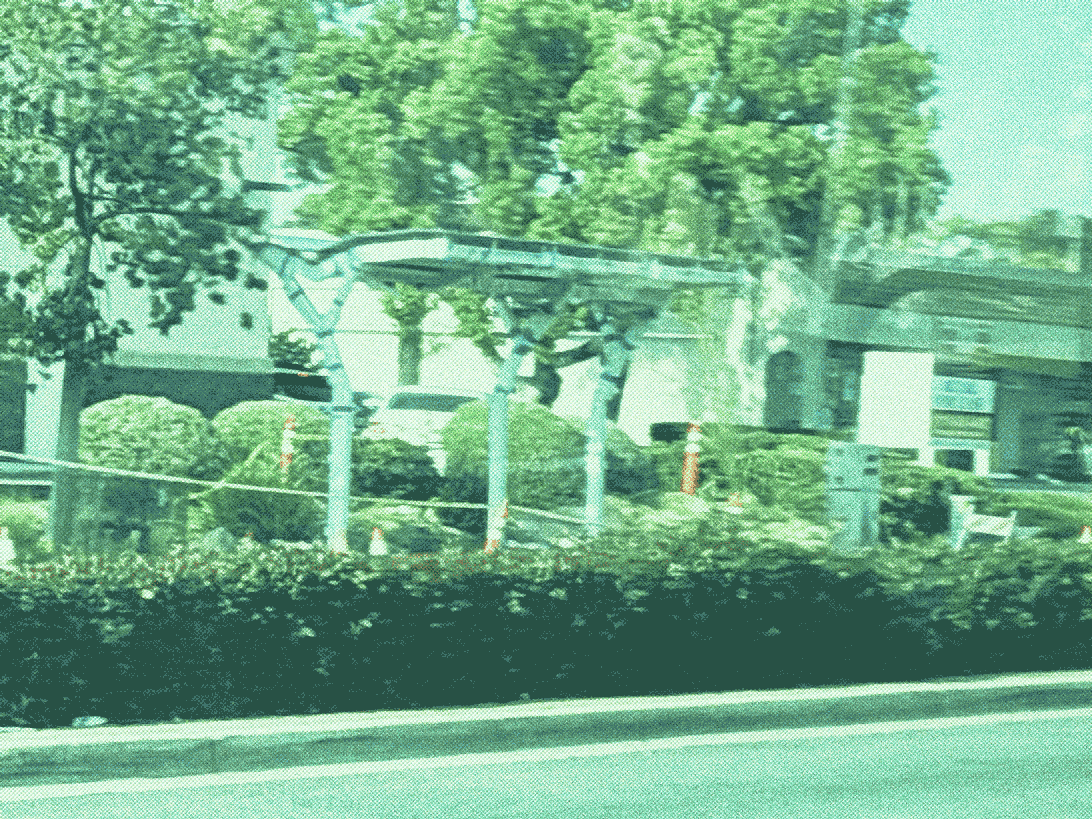 metal bus stop shelter structure with angled support pillars