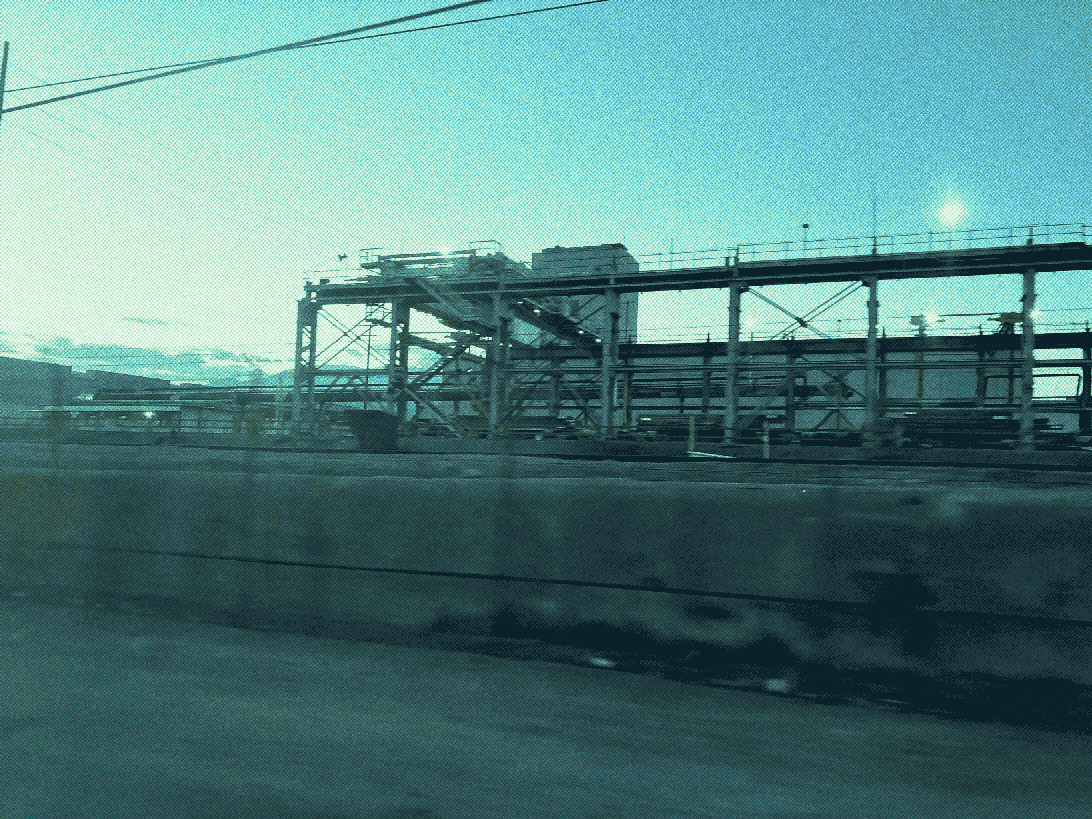 a large steel mill train loading facility with gantry cranes